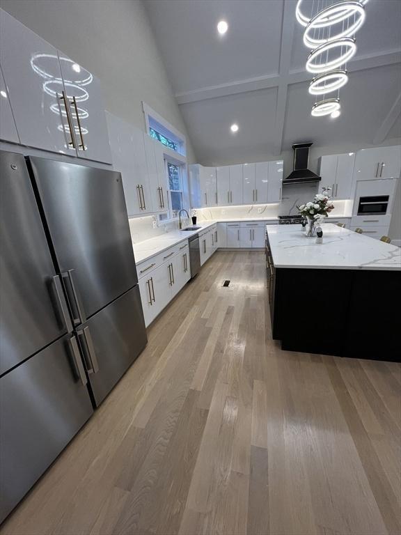 1 Harvard Ave, Burlington, MA 01803 - kitchen featuring stainless steel appliances, custom exhaust hood, pendant lighting, white cabinets, and light wood-style flooring
