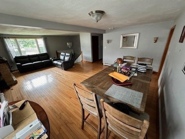 139 Westmoor Rd, Boston, MA 02132 - living area featuring hardwood / wood-style floors, a textured ceiling, and baseboard heating