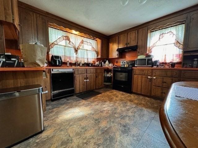 139 Westmoor Rd, Boston, MA 02132 - kitchen featuring black appliances, under cabinet range hood, brown cabinets, and dark countertops