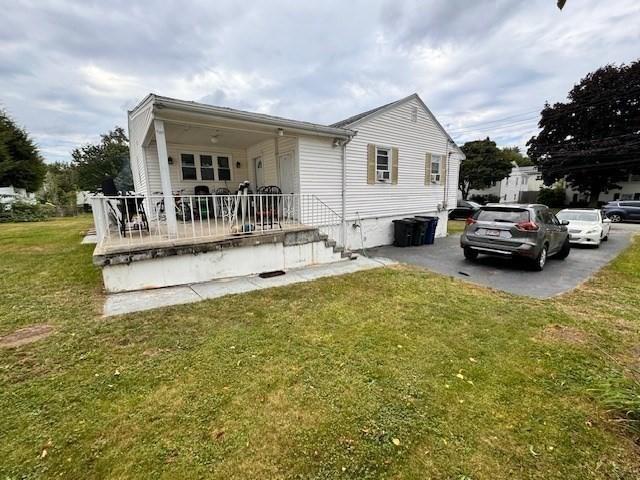 139 Westmoor Rd, Boston, MA 02132 - rear view of property with a yard and covered porch