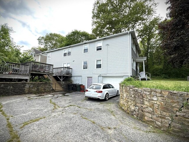 11 Park Rd, Webster, MA 01570 - rear view of property with asphalt driveway, an attached garage, a wooden deck, and stairway