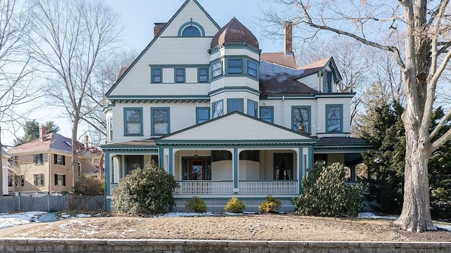 victorian-style house with a chimney and a porch