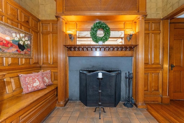 room details featuring a fireplace with flush hearth and ornate columns