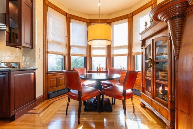 dining room featuring a baseboard radiator and parquet flooring