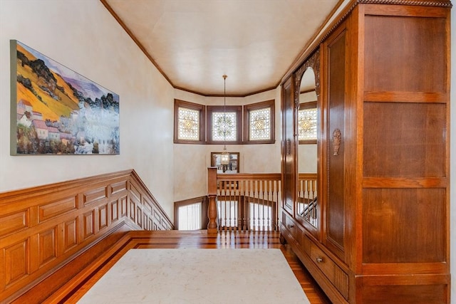 interior space with wood finished floors and crown molding