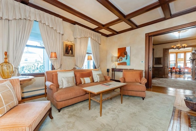 living room featuring plenty of natural light, coffered ceiling, a notable chandelier, and baseboard heating