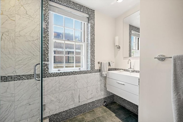 bathroom with vanity, tile walls, and an enclosed shower