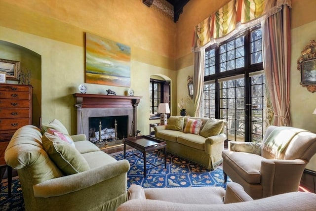 sitting room featuring a high ceiling and a fireplace