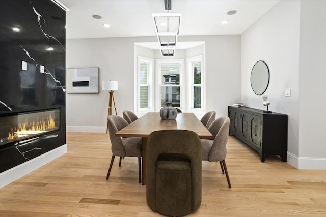 45 Sargent Ave, Somerville, MA 02145 - dining area with light wood-type flooring, baseboards, a large fireplace, and recessed lighting