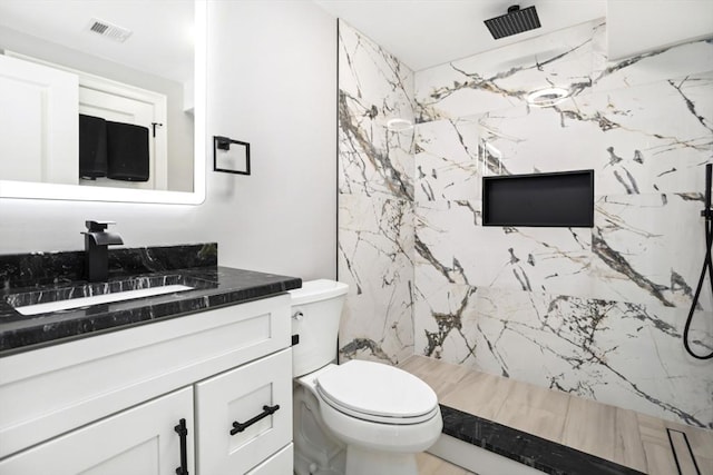 45 Sargent Ave, Somerville, MA 02145 - bathroom with vanity, toilet, and a marble finish shower