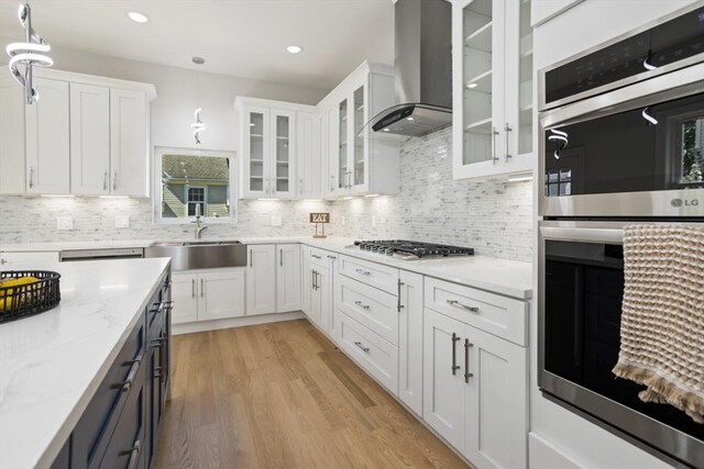45 Sargent Ave, Somerville, MA 02145 - kitchen with a sink, appliances with stainless steel finishes, wall chimney range hood, white cabinetry, and recessed lighting