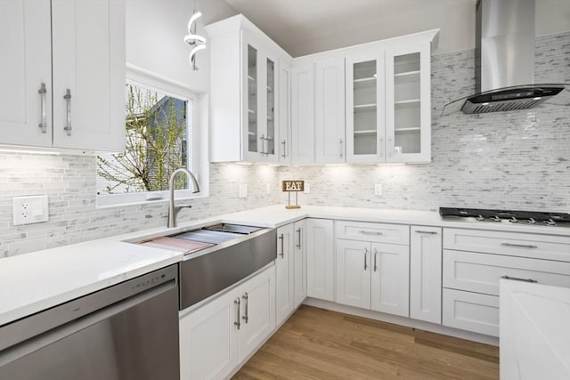 45 Sargent Ave, Somerville, MA 02145 - kitchen featuring dishwasher, wall chimney range hood, gas cooktop, decorative backsplash, and white cabinets