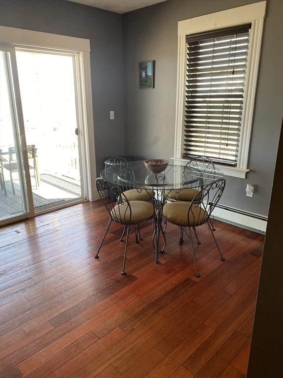 876 Shirley Unit 1, Winthrop, MA 02152 - dining area with healthy amount of natural light, hardwood / wood-style floors, and baseboard heating