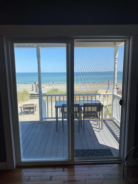 876 Shirley Unit 1, Winthrop, MA 02152 - doorway to outside with view of water and beach, plenty of natural light, and wood-type flooring