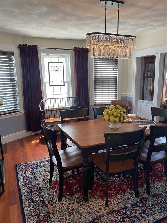 876 Shirley Unit 1, Winthrop, MA 02152 - dining space featuring a chandelier, hardwood / wood-style flooring, and plenty of natural light