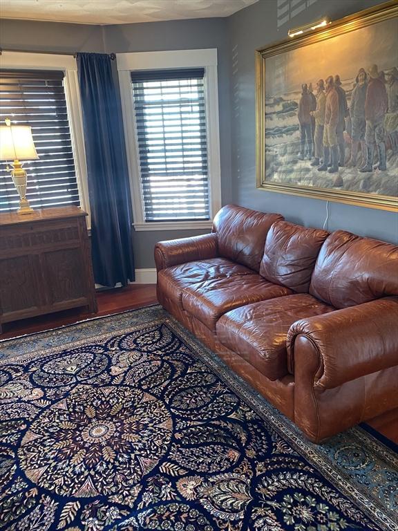876 Shirley Unit 1, Winthrop, MA 02152 - living room with baseboards and wood finished floors