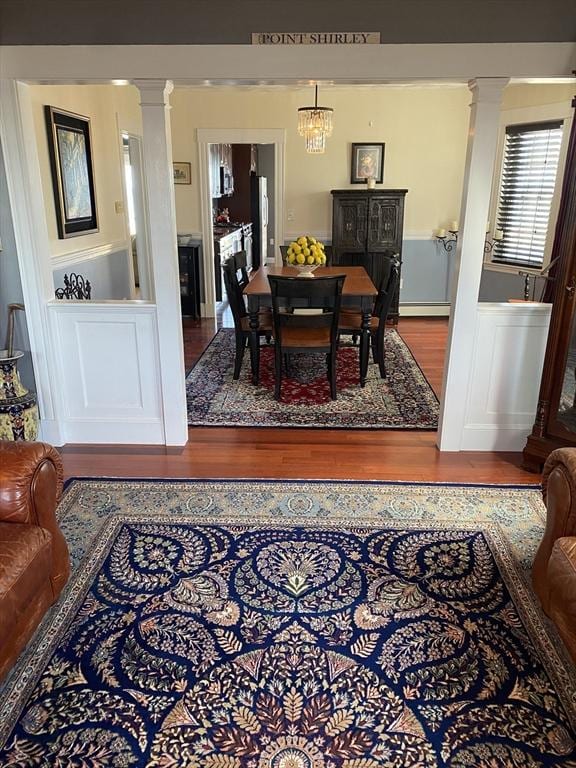 876 Shirley Unit 1, Winthrop, MA 02152 - dining room with ornate columns, wood finished floors, and wainscoting