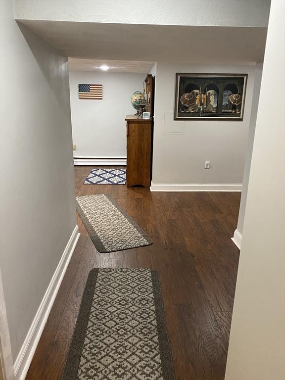 876 Shirley Unit 1, Winthrop, MA 02152 - hallway featuring wood finished floors and a baseboard radiator