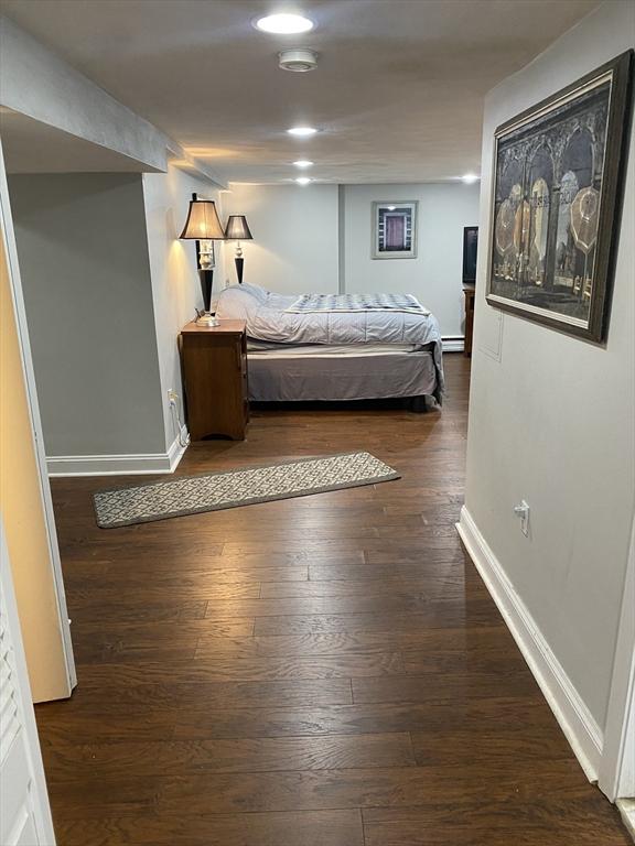 876 Shirley Unit 1, Winthrop, MA 02152 - bedroom with wood finished floors and a baseboard heating unit