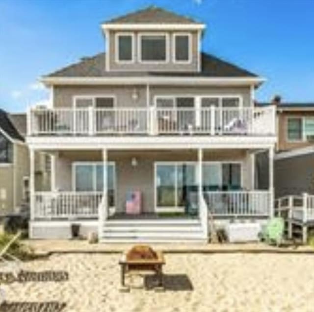 876 Shirley Unit 1, Winthrop, MA 02152 - back of property featuring a balcony, covered porch, and an outdoor fire pit