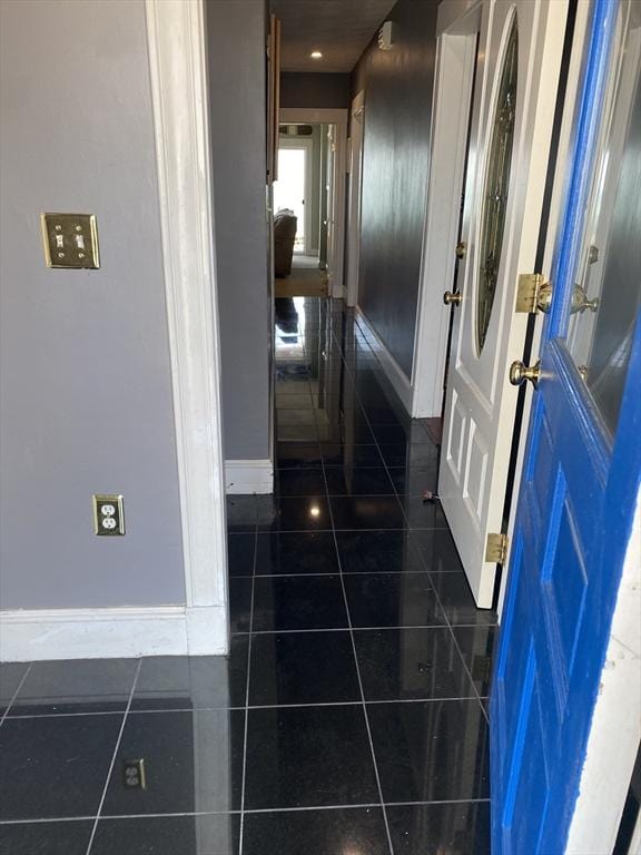 876 Shirley Unit 1, Winthrop, MA 02152 - hallway with dark tile patterned flooring and baseboards