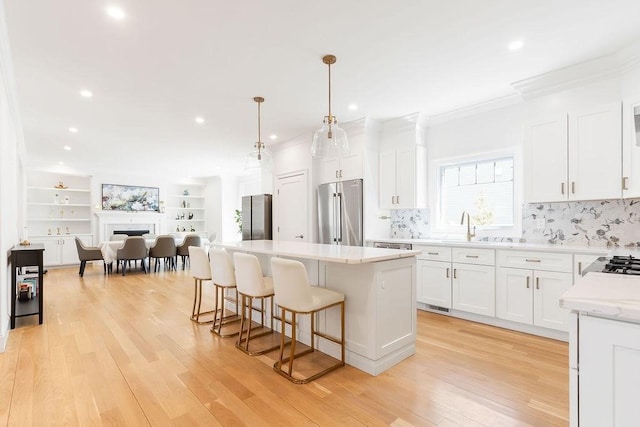 1 Marlin Rd, Boston, MA 02132 - kitchen featuring a breakfast bar, crown molding, a kitchen island, and high end fridge