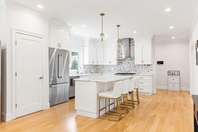 1 Marlin Rd, Boston, MA 02132 - kitchen featuring stainless steel appliances, wall chimney range hood, tasteful backsplash, a kitchen breakfast bar, and white cabinetry