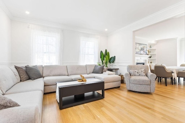 1 Marlin Rd, Boston, MA 02132 - living area featuring light wood finished floors, a fireplace, wainscoting, ornamental molding, and recessed lighting