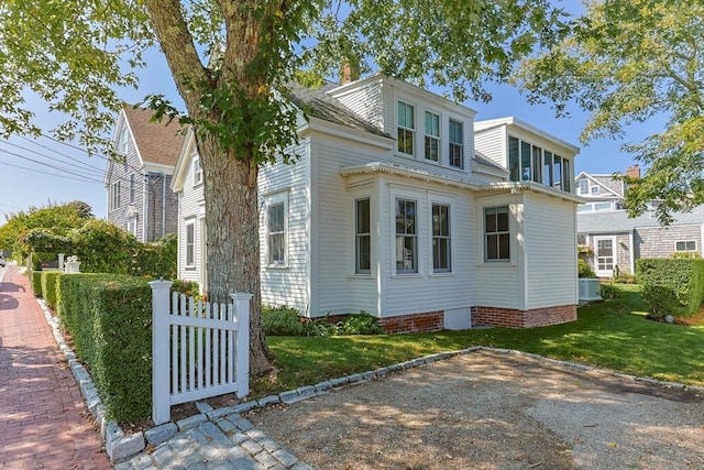 view of side of property with a yard