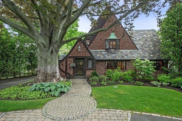 170 Atlantic Ave, Swampscott, MA 01907 - tudor-style house featuring a high end roof, a front yard, and brick siding