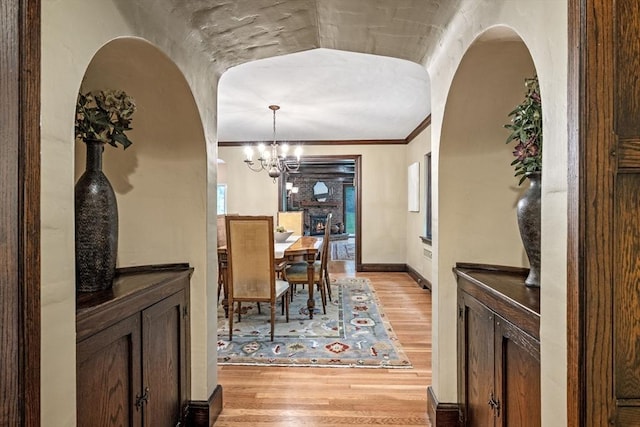 170 Atlantic Ave, Swampscott, MA 01907 - dining space featuring light wood-style floors, a chandelier, healthy amount of natural light, and crown molding