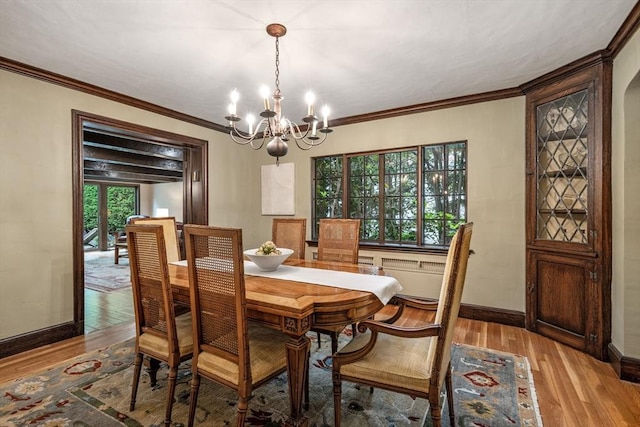 170 Atlantic Ave, Swampscott, MA 01907 - dining space with a chandelier, light wood-type flooring, and crown molding