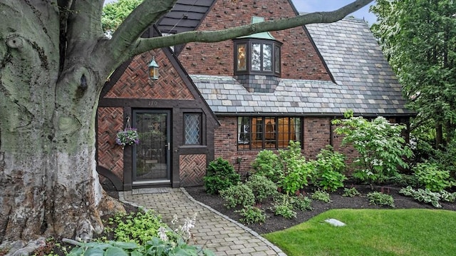 170 Atlantic Ave, Swampscott, MA 01907 - view of front of house featuring a high end roof, brick siding, and a chimney