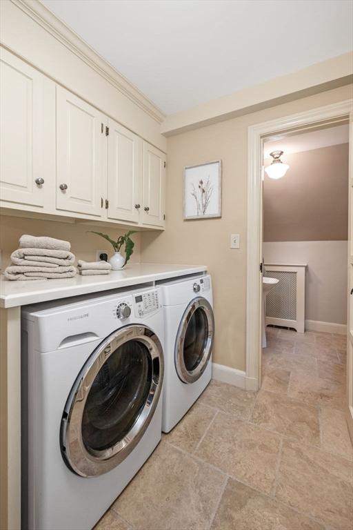 170 Atlantic Ave, Swampscott, MA 01907 - washroom featuring cabinet space, washer and dryer, and light stone finish flooring