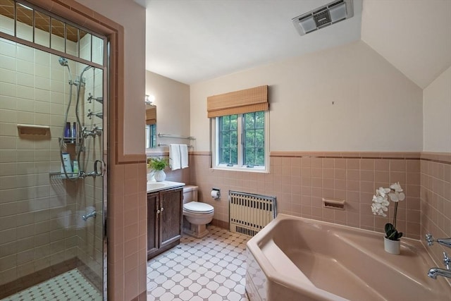 170 Atlantic Ave, Swampscott, MA 01907 - full bathroom with radiator, tile walls, vanity, a garden tub, and a wainscoted wall