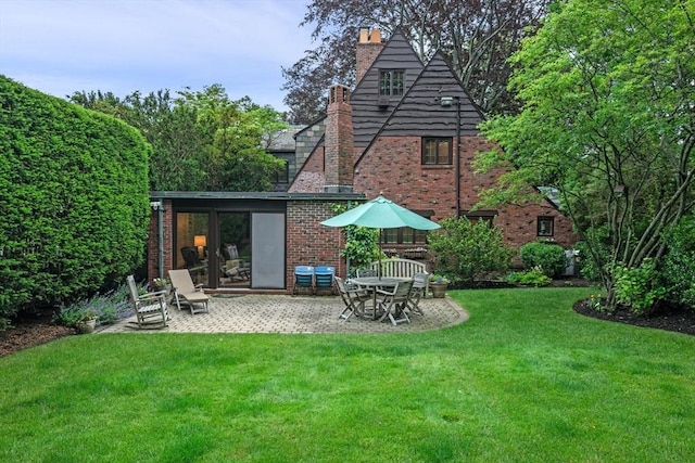 170 Atlantic Ave, Swampscott, MA 01907 - back of house featuring a chimney, a patio area, a lawn, and brick siding