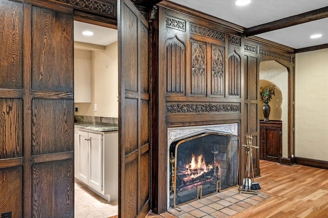 170 Atlantic Ave, Swampscott, MA 01907 - detailed view of a fireplace with flush hearth, wood finished floors, crown molding, recessed lighting, and beamed ceiling