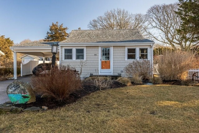 view of front facade featuring a front yard and a carport