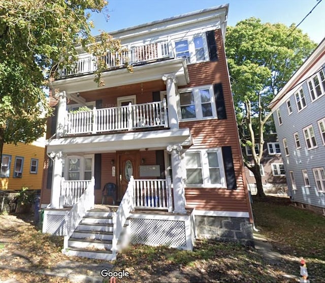 townhome / multi-family property featuring a porch and a balcony