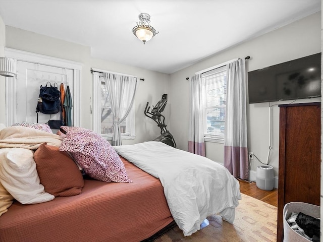 bedroom with a closet and wood finished floors