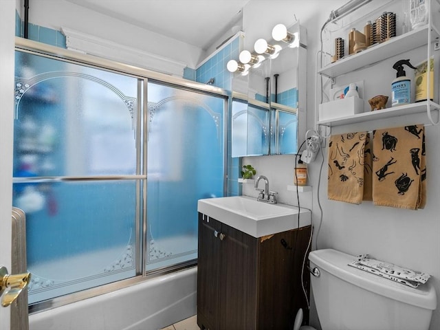 bathroom with vanity, toilet, and shower / bath combination with glass door