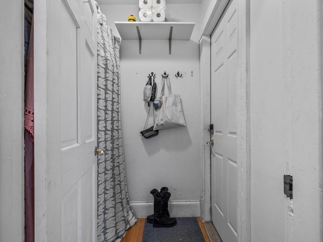 mudroom featuring baseboards and wood finished floors