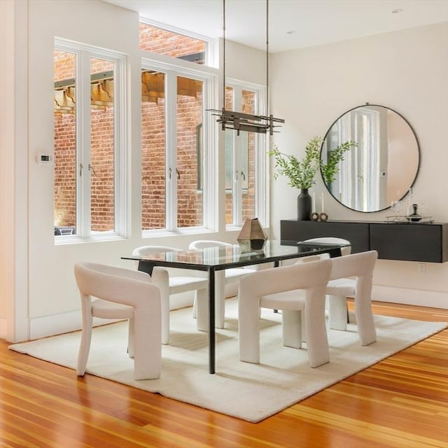 dining area with hardwood / wood-style floors and a notable chandelier