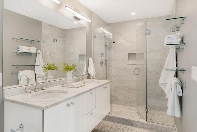 bathroom with a shower with door and vanity