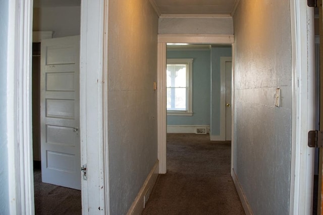 corridor featuring crown molding and dark carpet