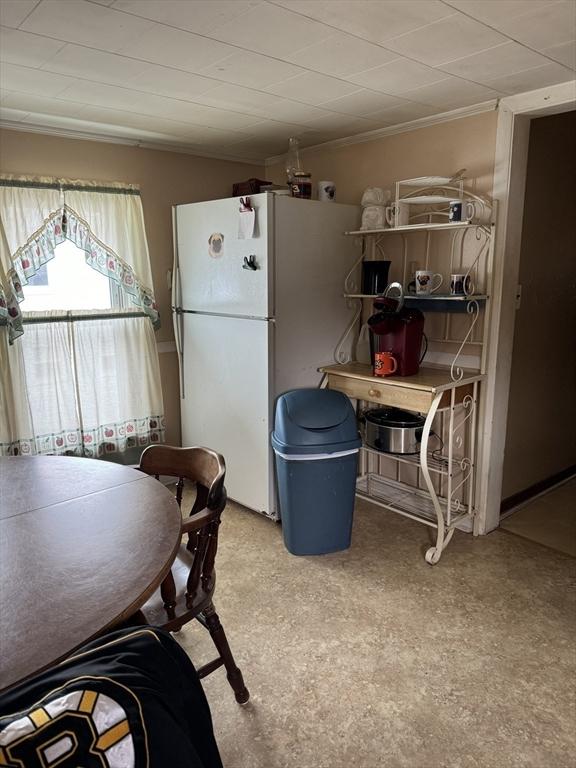 dining space featuring crown molding