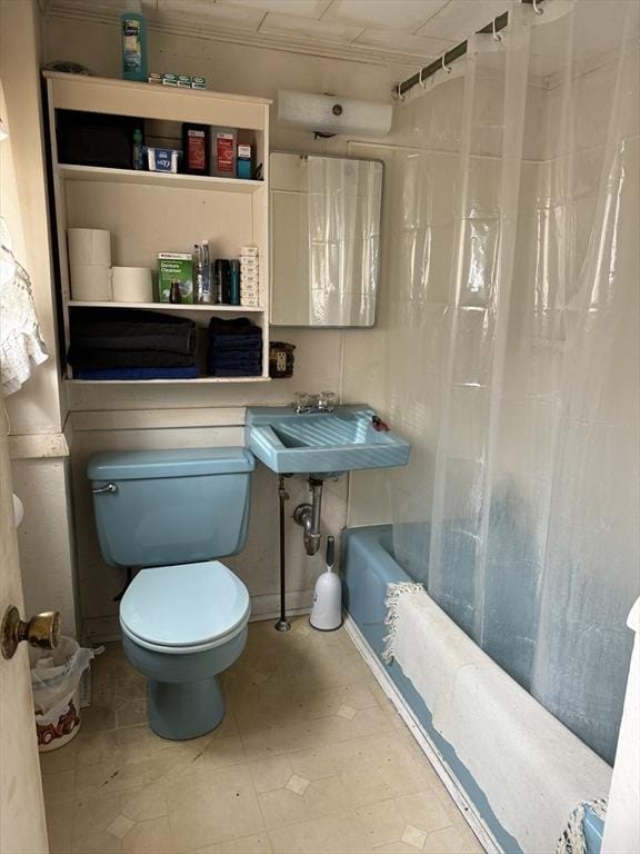 full bathroom with toilet, shower / bath combination with curtain, and sink