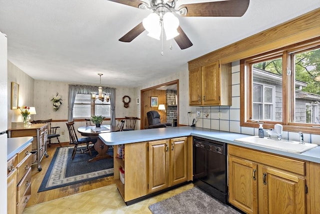 kitchen featuring dishwasher, a sink, healthy amount of natural light, and light countertops