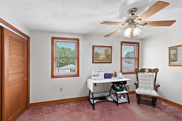 carpeted home office with baseboards and ceiling fan