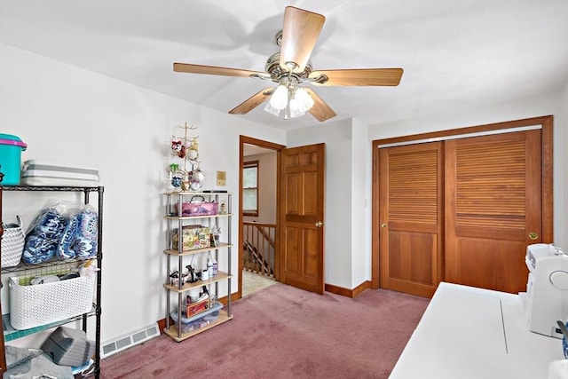 carpeted home office with ceiling fan and baseboards